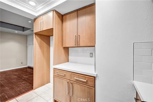 a kitchen with a refrigerator and cabinets