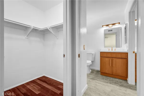 a view of bathroom with a toilet sink and mirror