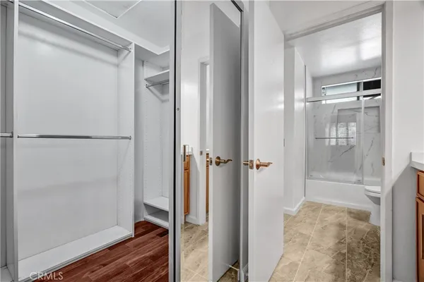 a bathroom with a glass shower door and mirror