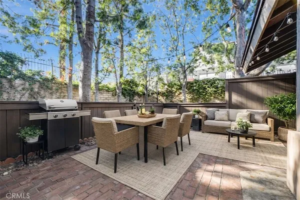 a view of a patio with table and chairs and potted plants