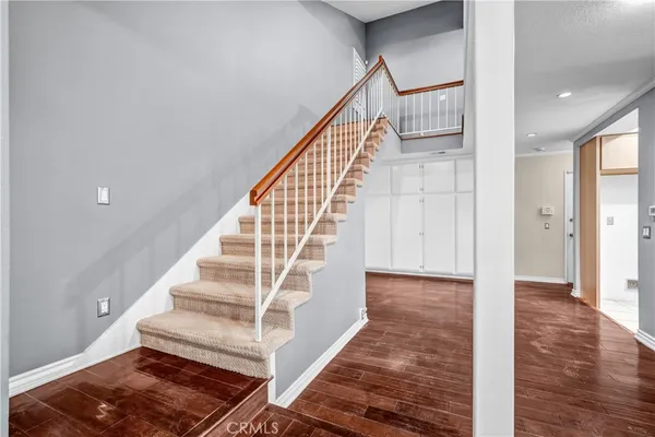 a view of entryway and hall with wooden floor