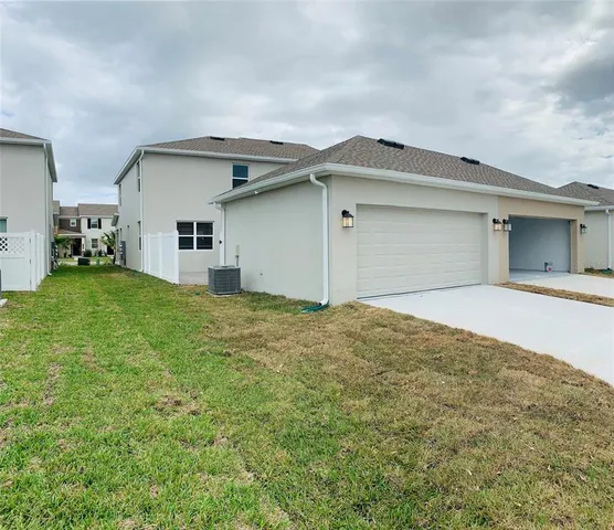 a view of a swimming pool with a lawn chairs under an umbrella