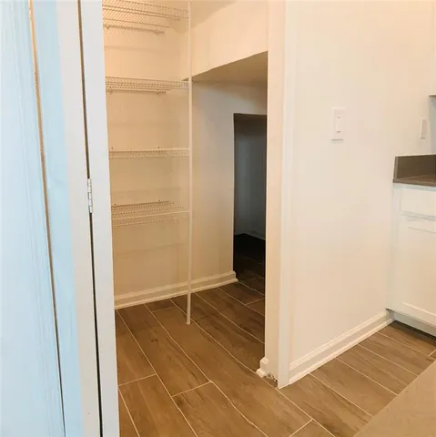 a view of hallway with wooden floor