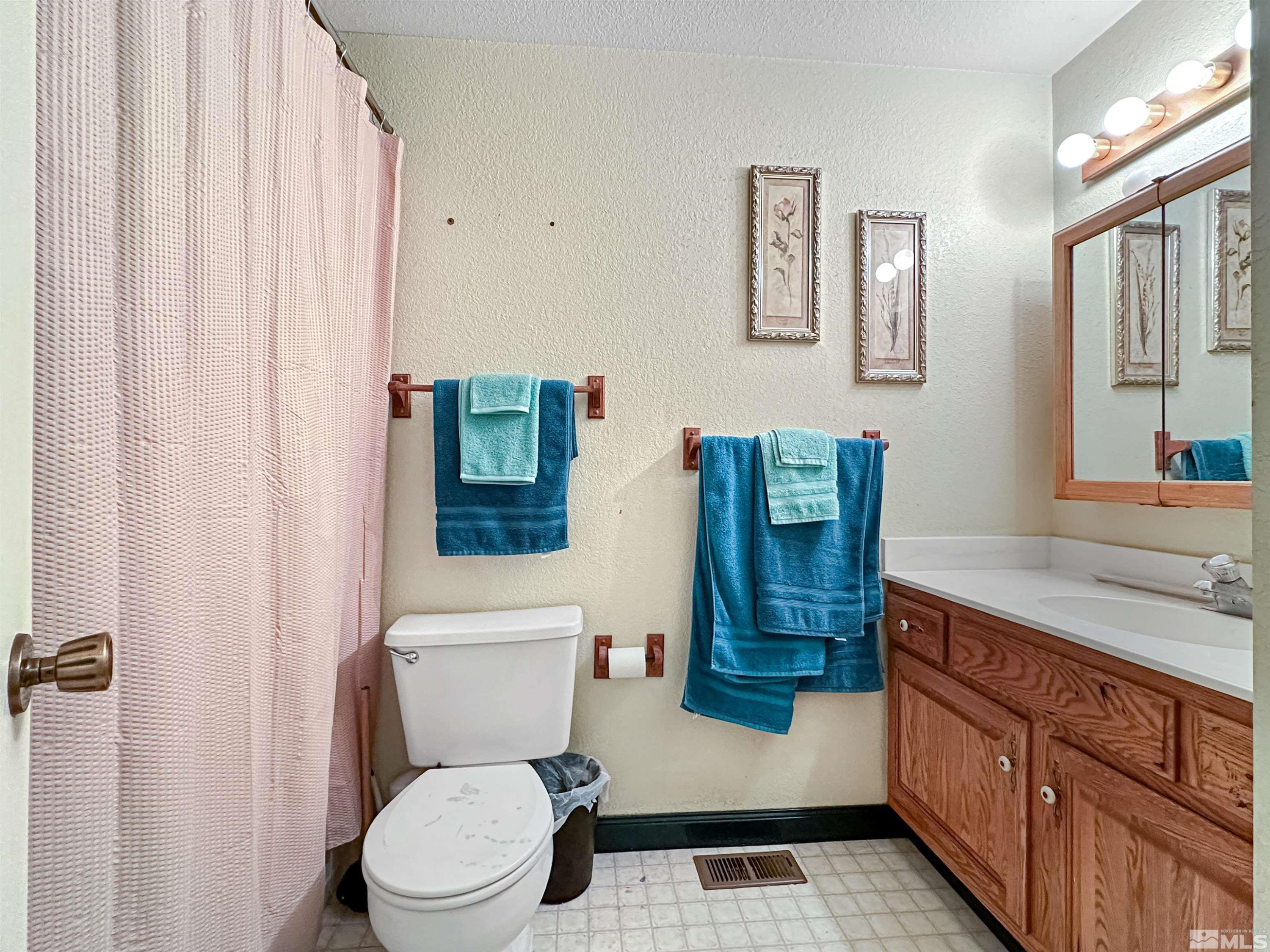 11595 Vicksburg Road Reno, NV 89508 - Photo 11 of 18 a bathroom with a granite countertop toilet sink and mirror