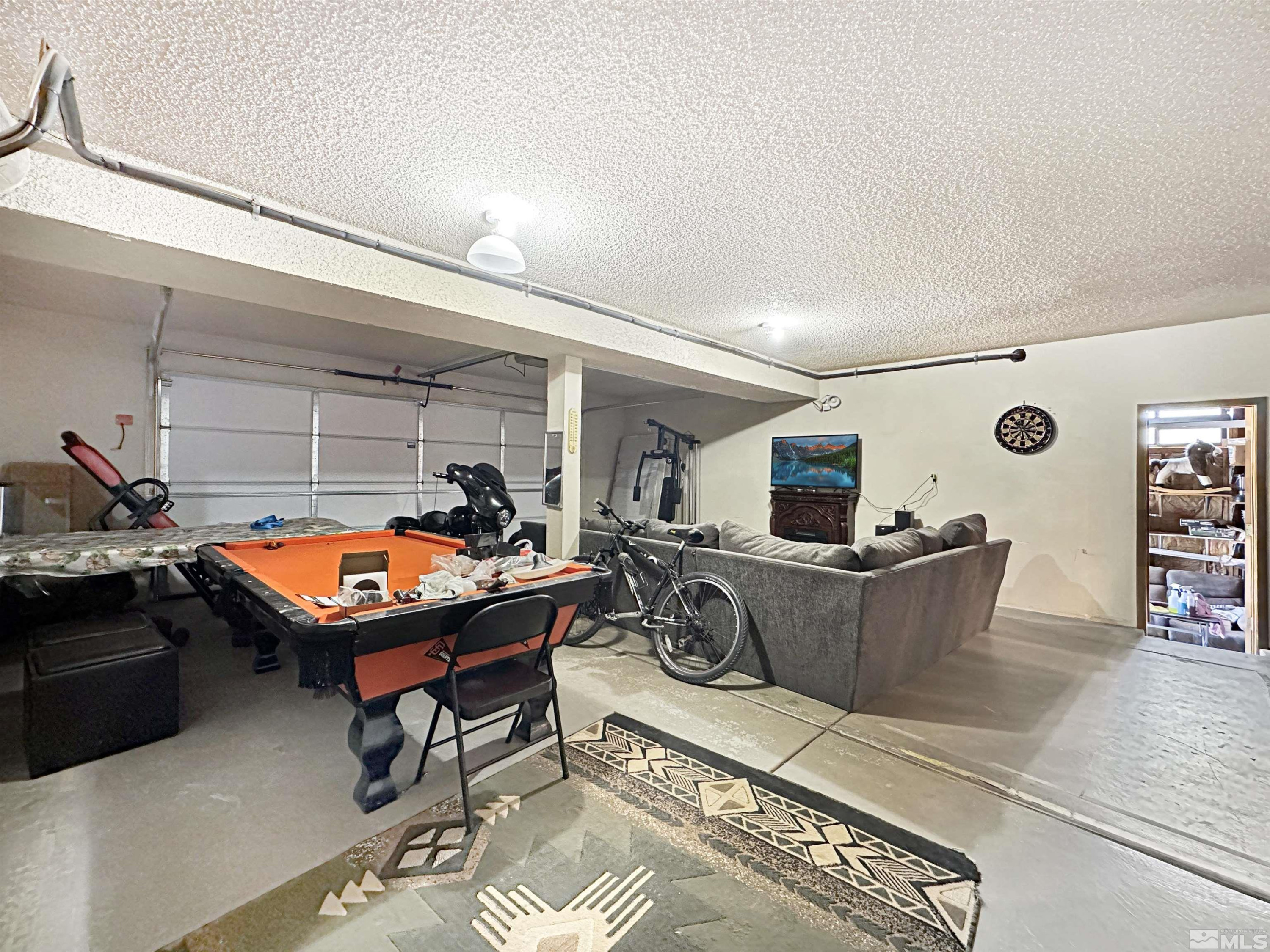 11595 Vicksburg Road Reno, NV 89508 - Photo 15 of 18 a room with furniture a flat screen tv and a table