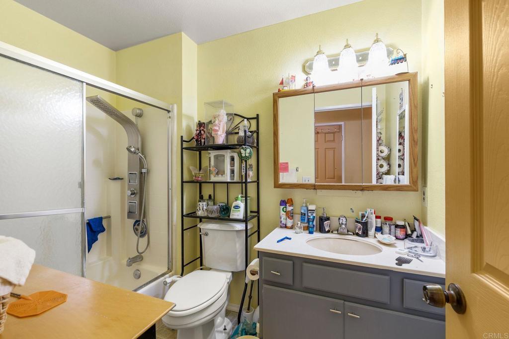 1518 Goldrush Way Oceanside, CA 92057 - Photo 18 of 36 a bathroom with a sink a toilet and shower