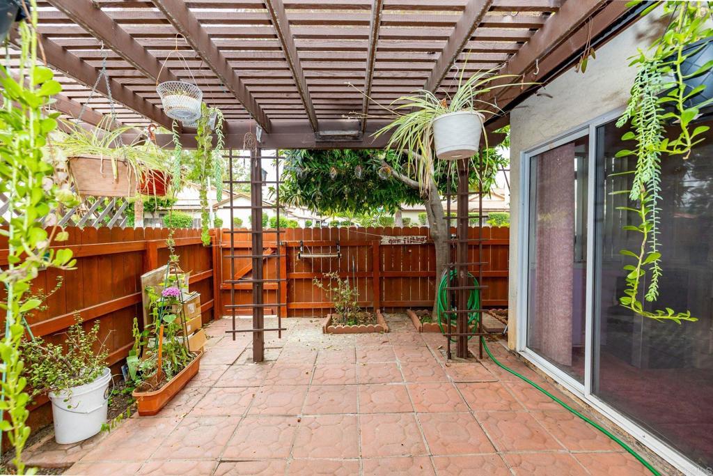 1518 Goldrush Way Oceanside, CA 92057 - Photo 19 of 36 a view of a patio with table and chairs potted plants