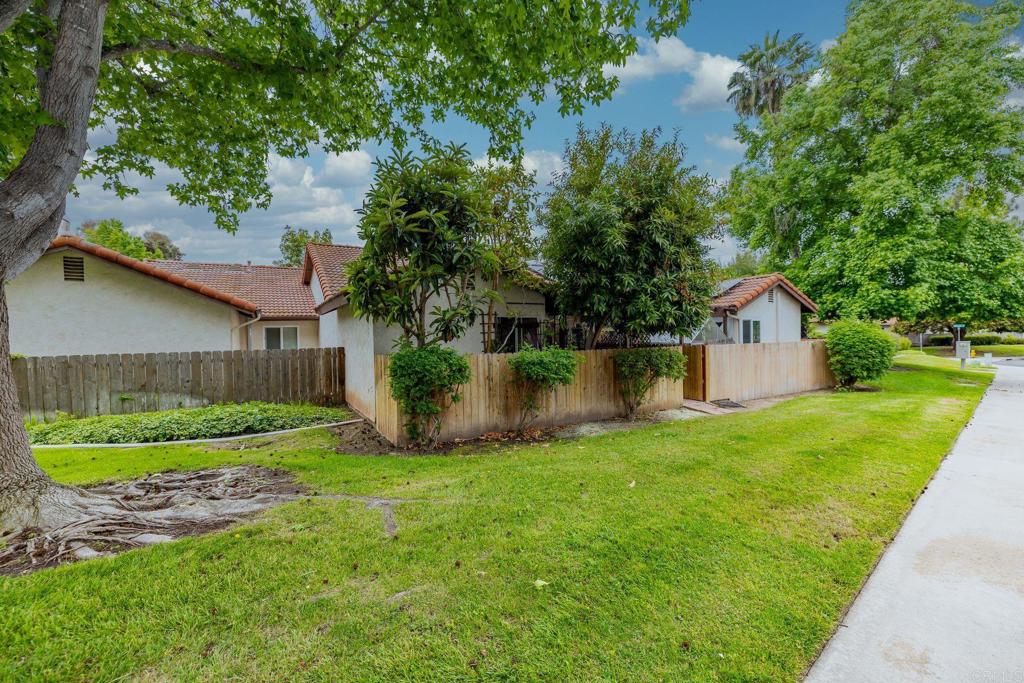 1518 Goldrush Way Oceanside, CA 92057 - Photo 22 of 36 a view of a house with a yard and a large tree