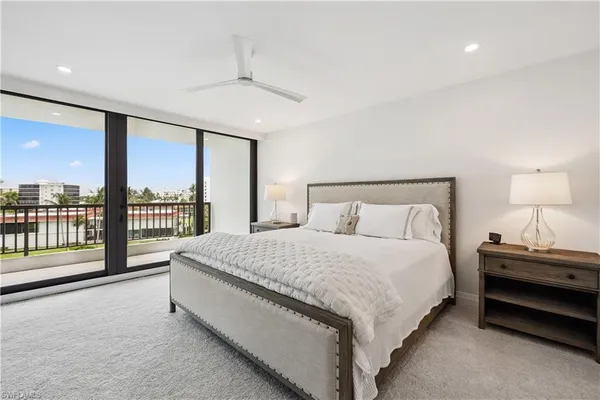 a spacious bedroom with a bed and a large window