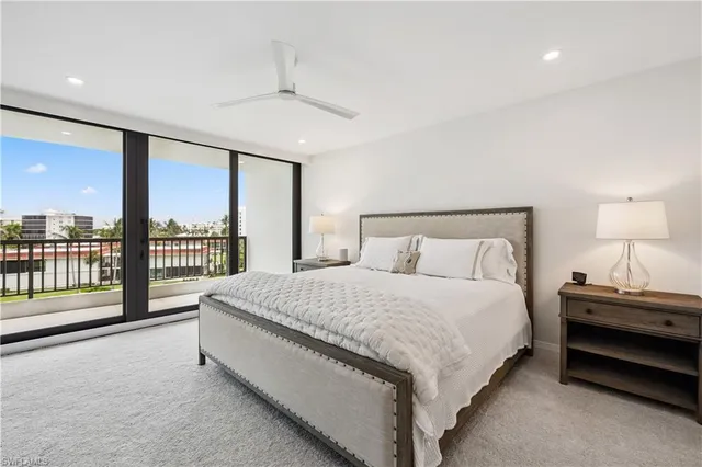 a spacious bedroom with a bed and a large window