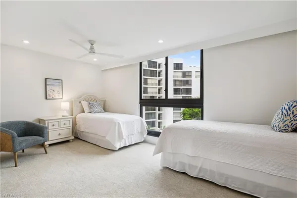 a bedroom with a bed furniture and windows