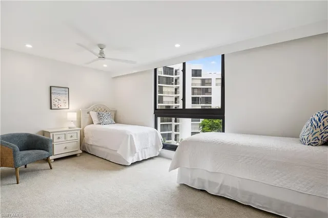 a bedroom with a bed furniture and windows