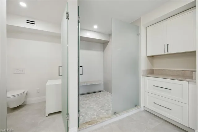a bathroom with a toilet sink and shower