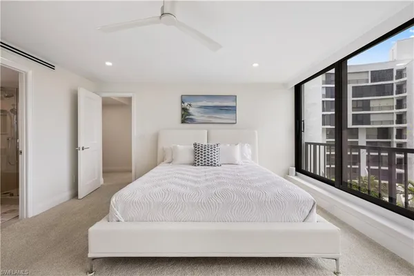 a large white bed in a white room