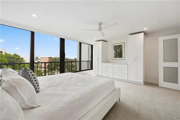 a bedroom with a large bed and a large window