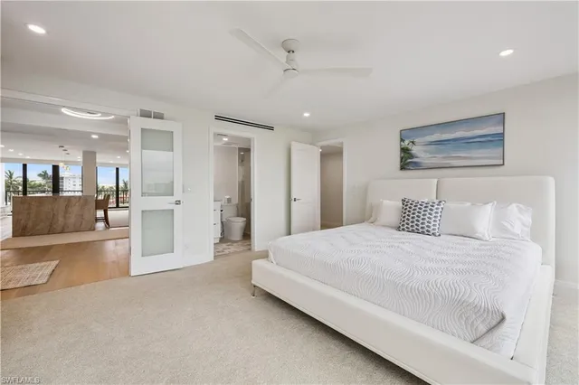 a spacious bedroom with a bed and a large mirror