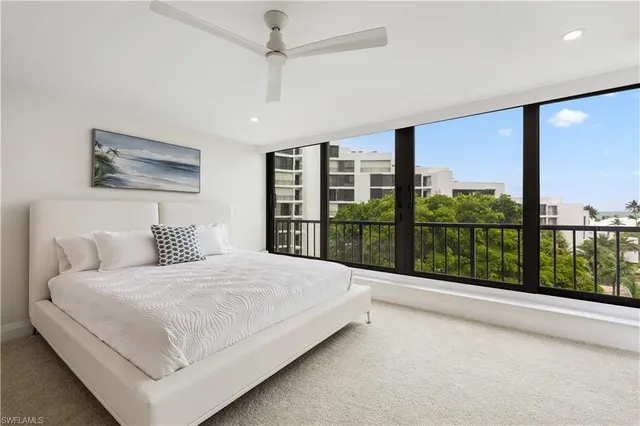 a bedroom with a large bed and a large window