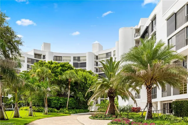 a front view of a residential apartment building with a yard