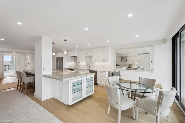 a view of kitchen with cabinets table and chairs