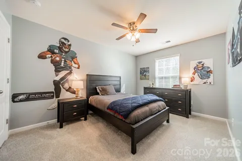 a bed room with a bed and a chandelier