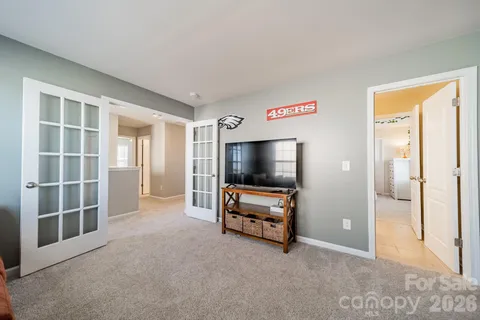 a view of a livingroom with furniture and a flat screen tv