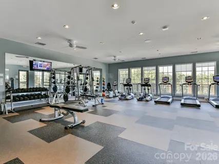 a view of a room with gym equipment and floor to ceiling window