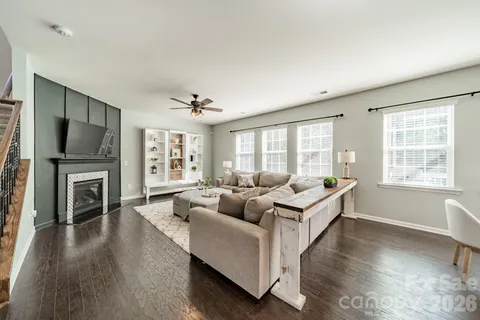 a living room with furniture fireplace and flat screen tv