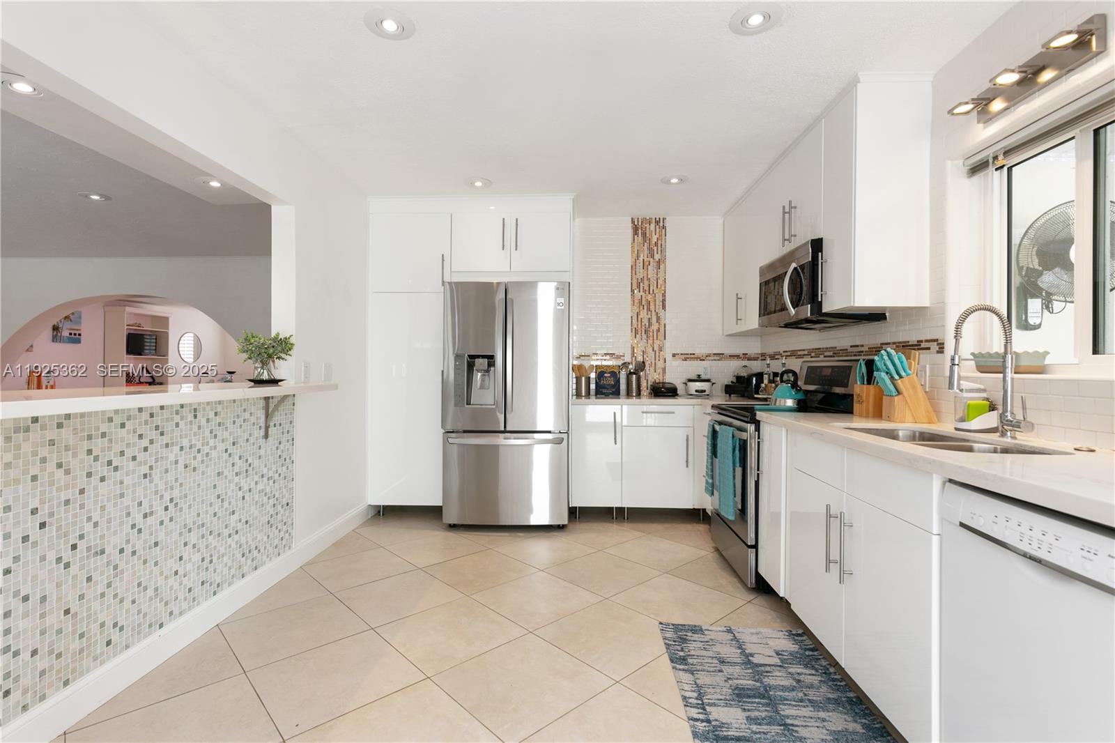 1900 North Victoria Park Road Fort Lauderdale, FL 33305 - Photo 11 of 60 a kitchen with stainless steel appliances a refrigerator sink and cabinets