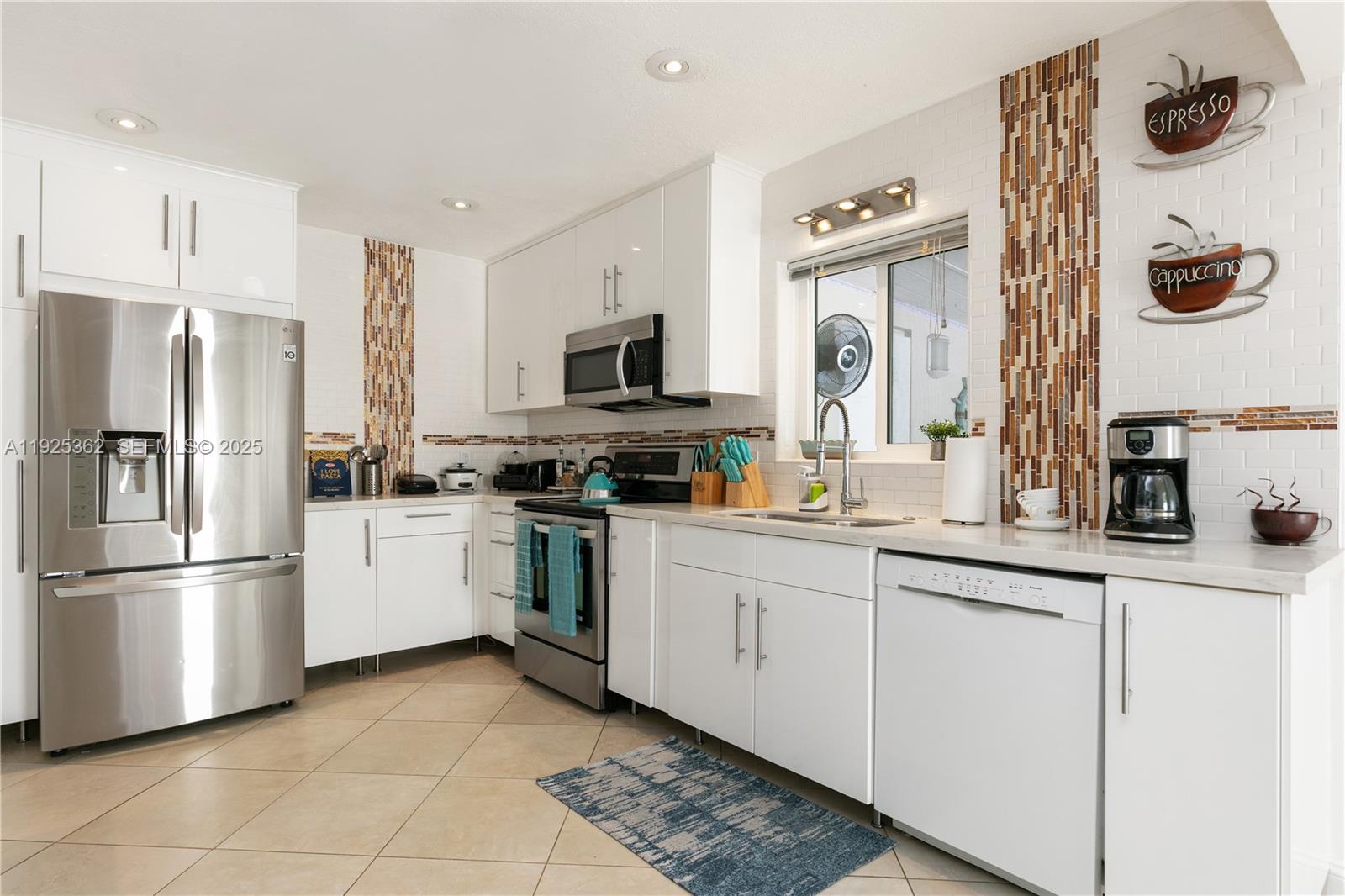 1900 North Victoria Park Road Fort Lauderdale, FL 33305 - Photo 13 of 60 a kitchen with stainless steel appliances granite countertop a refrigerator a stove and a sink