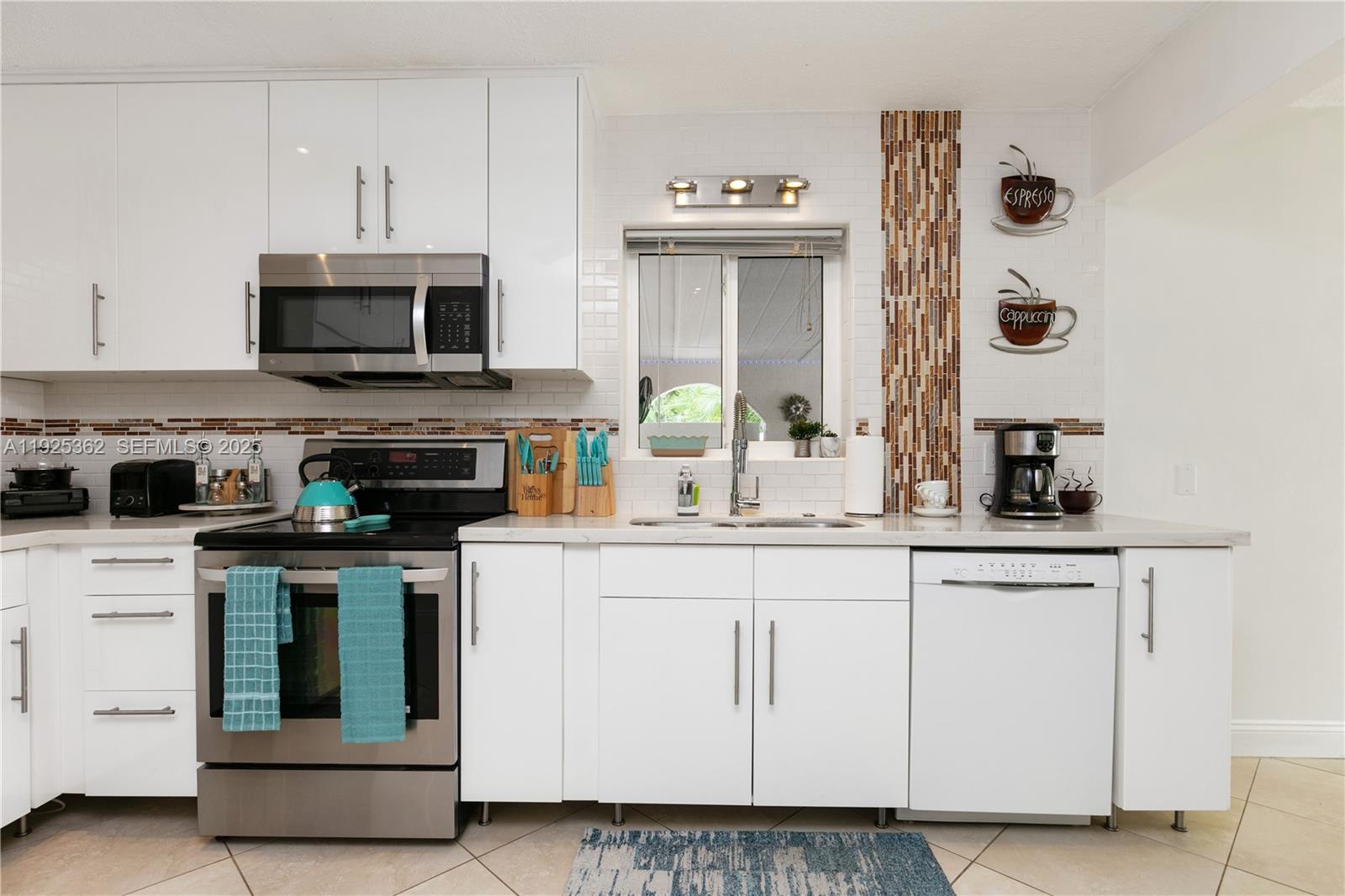 1900 North Victoria Park Road Fort Lauderdale, FL 33305 - Photo 14 of 60 a kitchen with cabinets and appliances