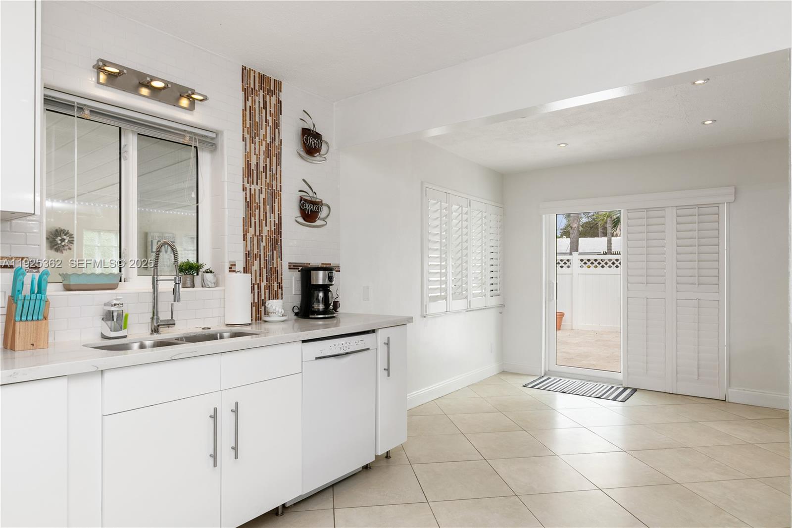 1900 North Victoria Park Road Fort Lauderdale, FL 33305 - Photo 15 of 60 a bathroom with a double vanity sink a mirror and a