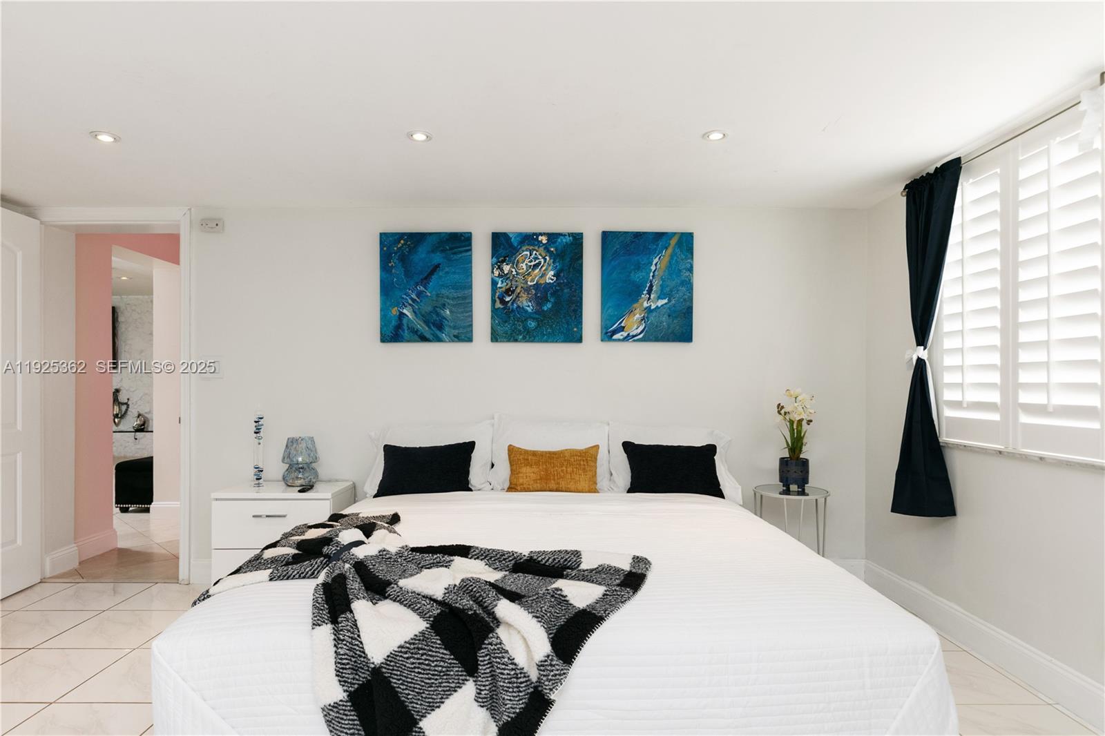 1900 North Victoria Park Road Fort Lauderdale, FL 33305 - Photo 19 of 60 a bedroom with a bed and a large window