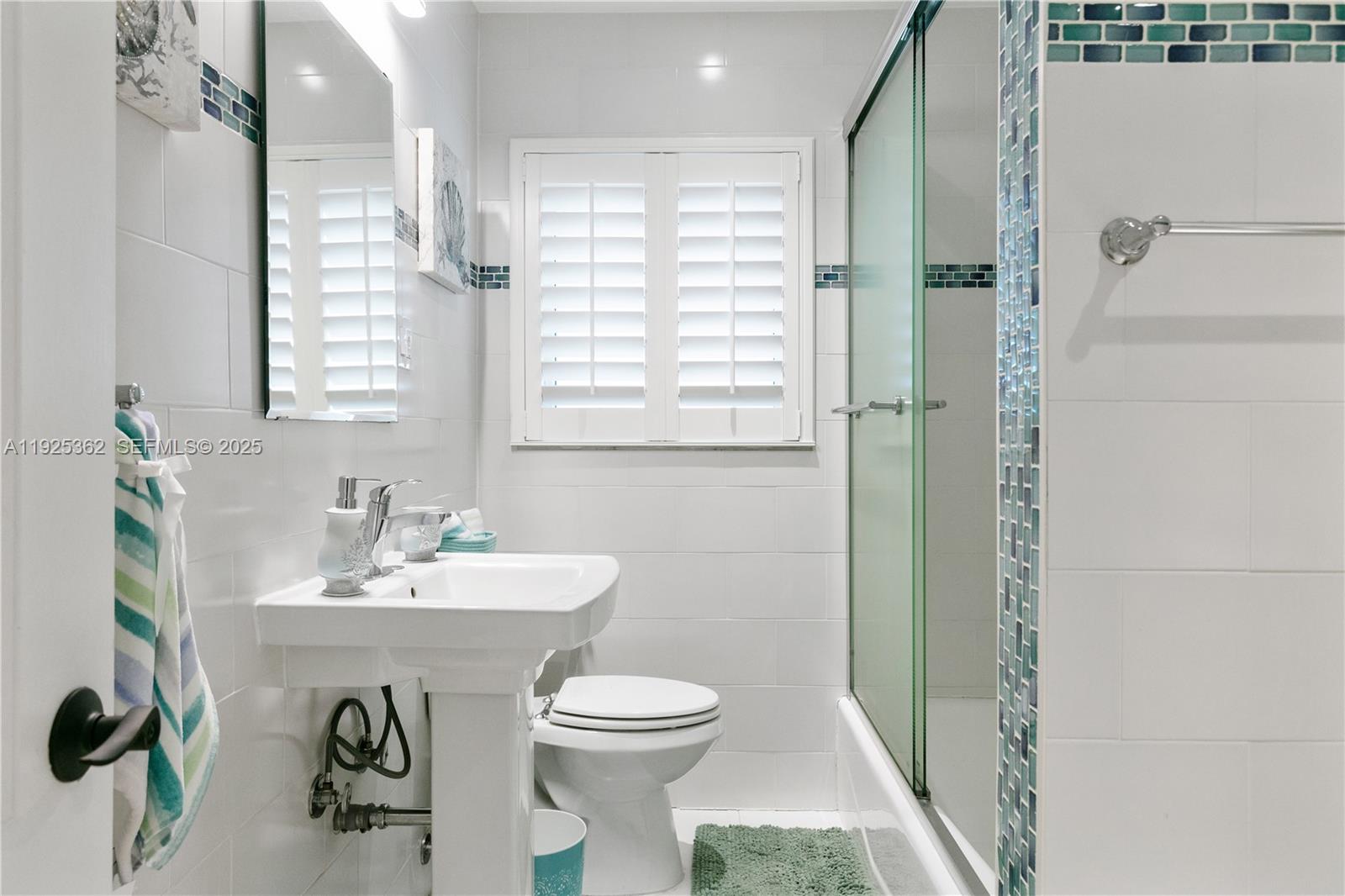 1900 North Victoria Park Road Fort Lauderdale, FL 33305 - Photo 28 of 60 a bathroom with a sink a toilet and shower