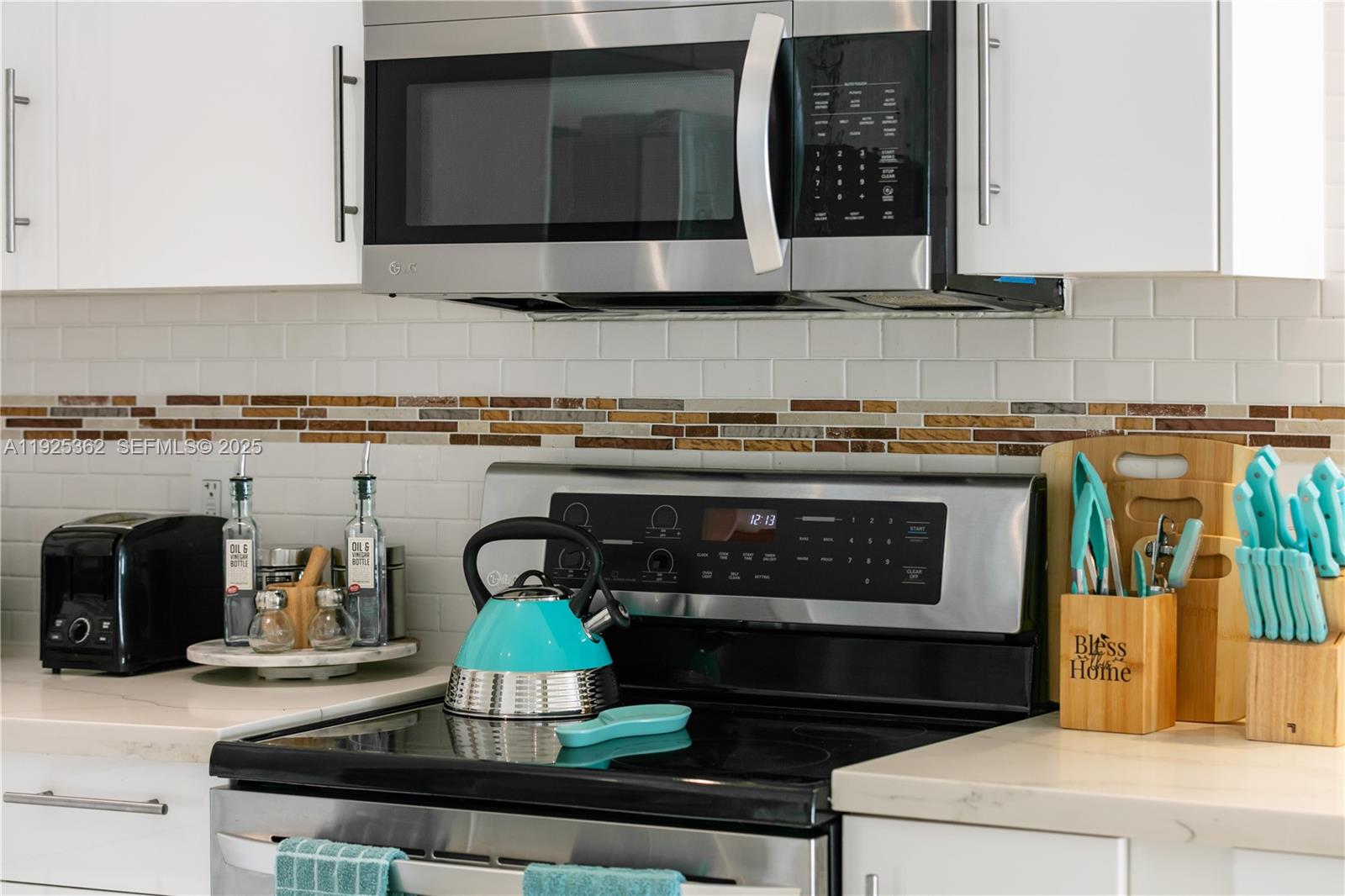 1900 North Victoria Park Road Fort Lauderdale, FL 33305 - Photo 33 of 60 a kitchen with a stove and a microwave