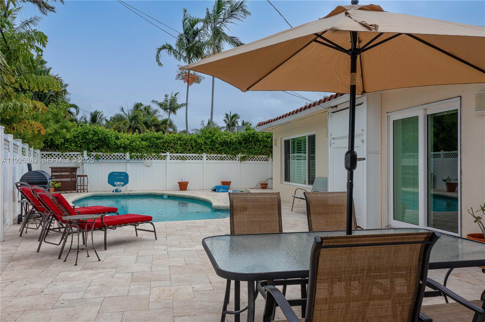 1900 North Victoria Park Road Fort Lauderdale, FL 33305 - Photo 39 of 60 a backyard of a house with table and chairs