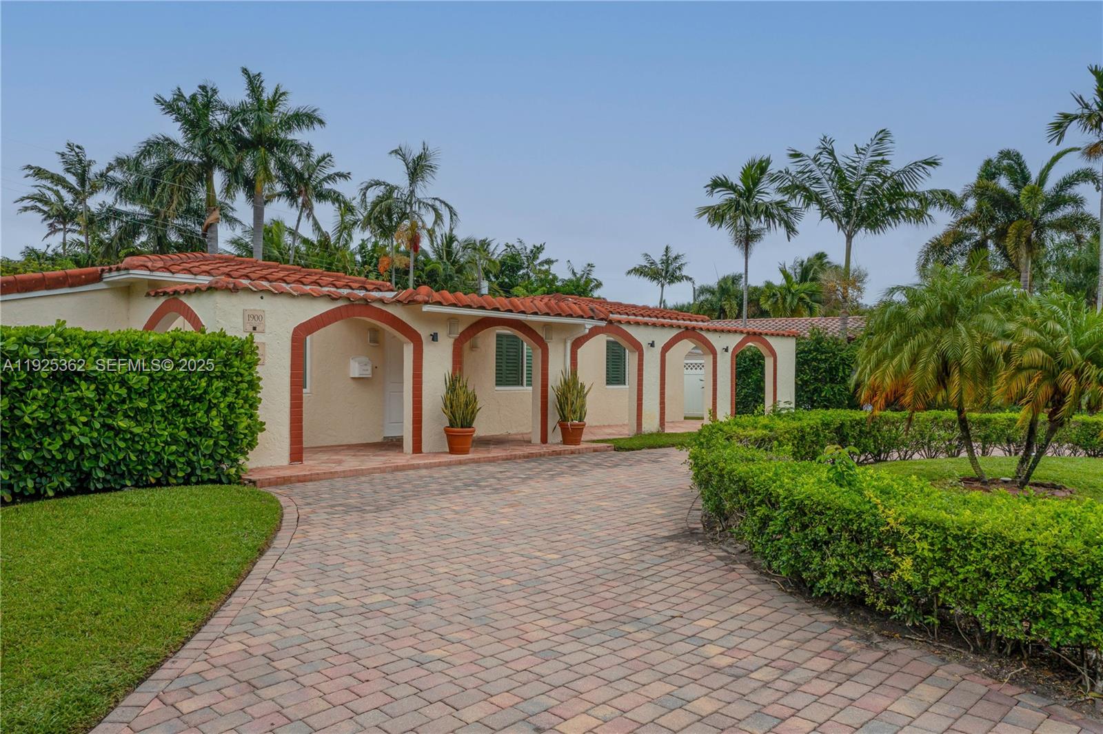 1900 North Victoria Park Road Fort Lauderdale, FL 33305 - Photo 45 of 60 a front view of a house with a yard and garage