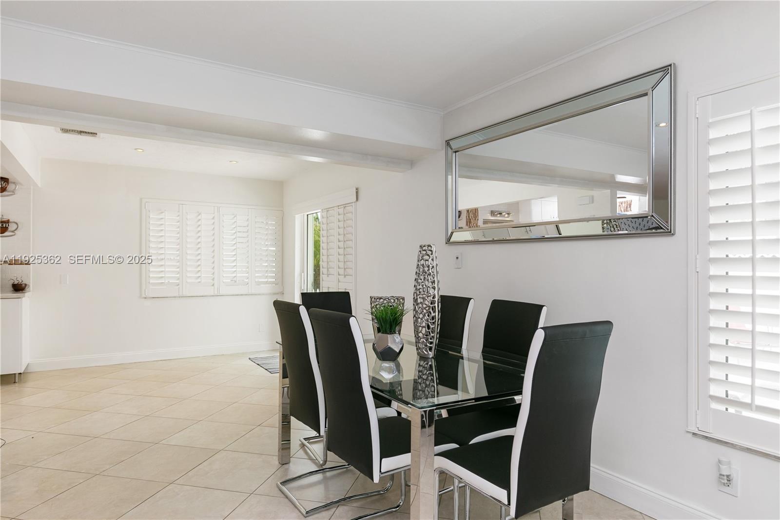 1900 North Victoria Park Road Fort Lauderdale, FL 33305 - Photo 10 of 60 a view of a dining room with furniture and windows