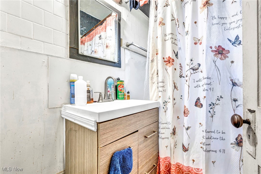 872 Rondel Road Cleveland, OH 44110 - Photo 21 of 25 Bathroom featuring vanity and a shower with shower curtain