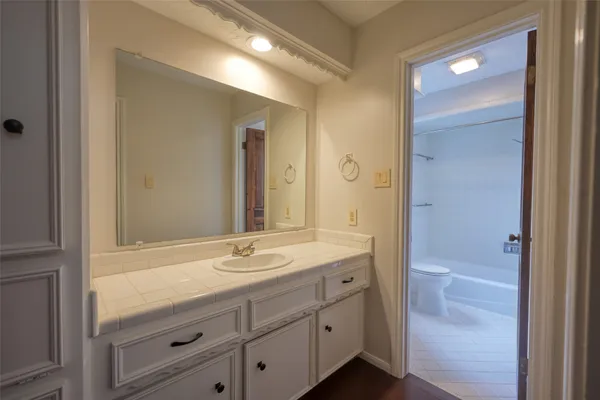 a bathroom with a granite countertop sink mirror and double