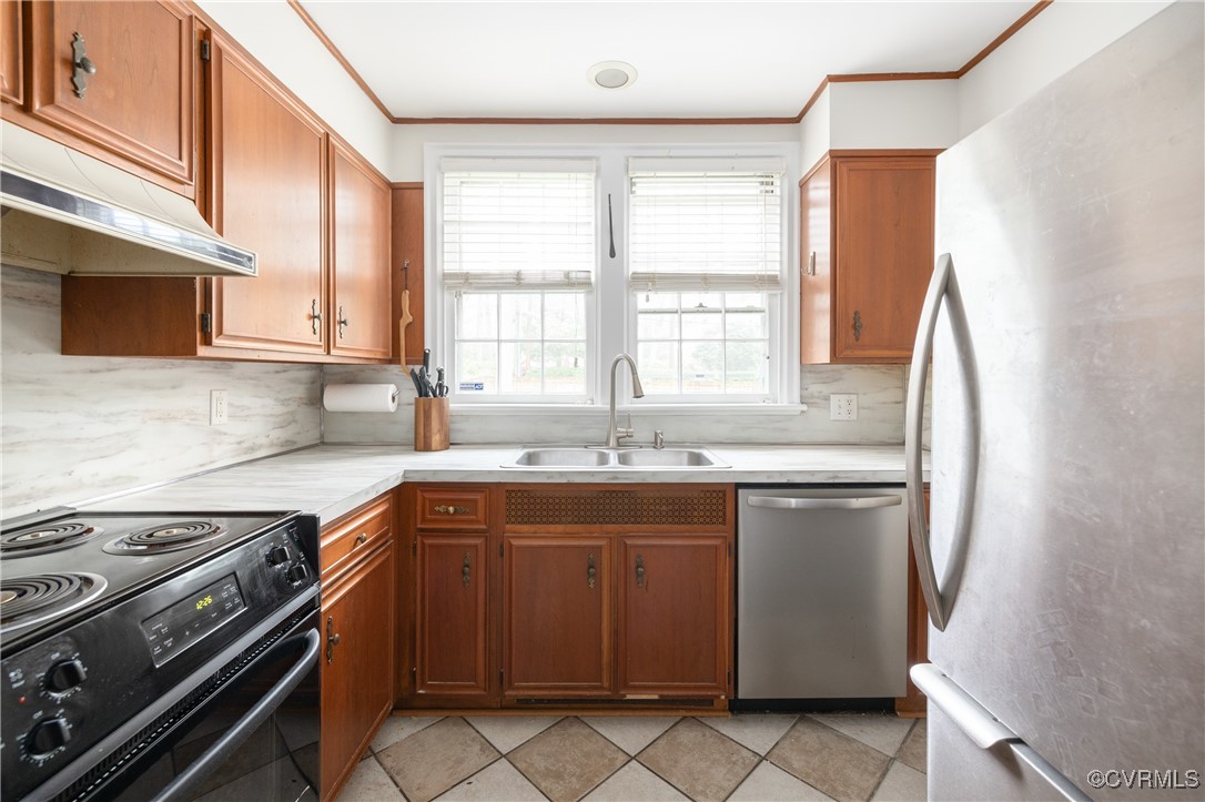 5217 Sylvan Road Richmond, VA 23225 - Photo 15 of 46 a kitchen with stainless steel appliances granite countertop a sink stove and refrigerator