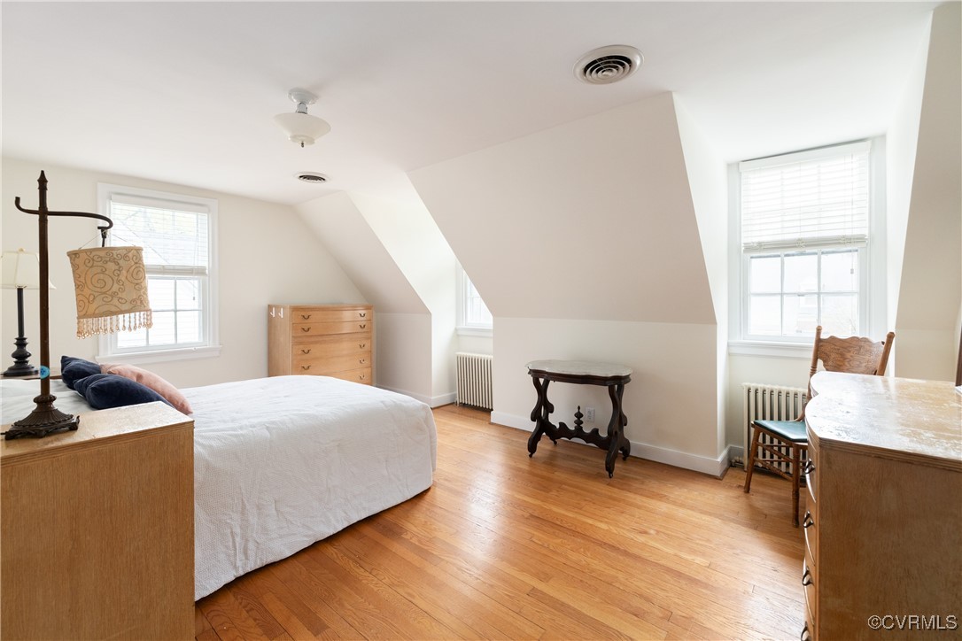 5217 Sylvan Road Richmond, VA 23225 - Photo 20 of 46 a bedroom with a bed and wooden floor