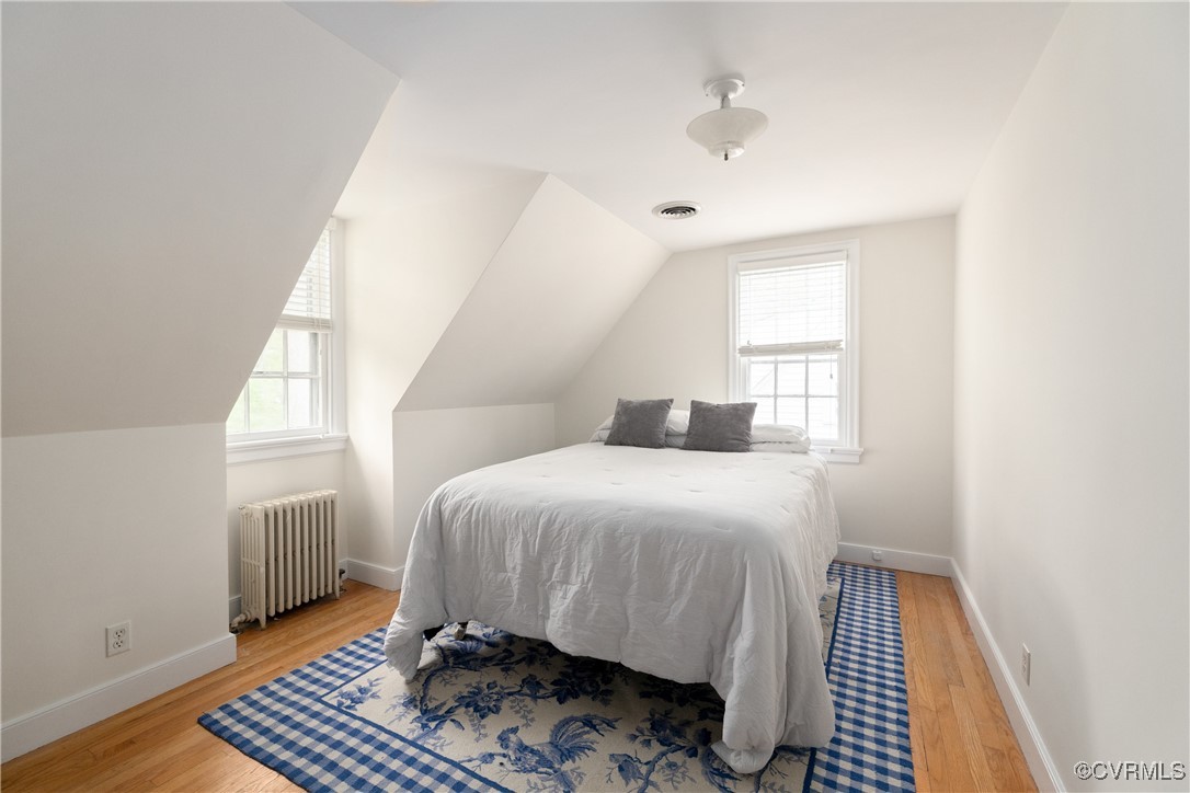 5217 Sylvan Road Richmond, VA 23225 - Photo 23 of 46 a bedroom with a bed and wooden floor