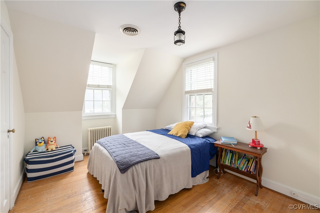 5217 Sylvan Road Richmond, VA 23225 - Photo 27 of 46 a bedroom with a bed and wooden floor