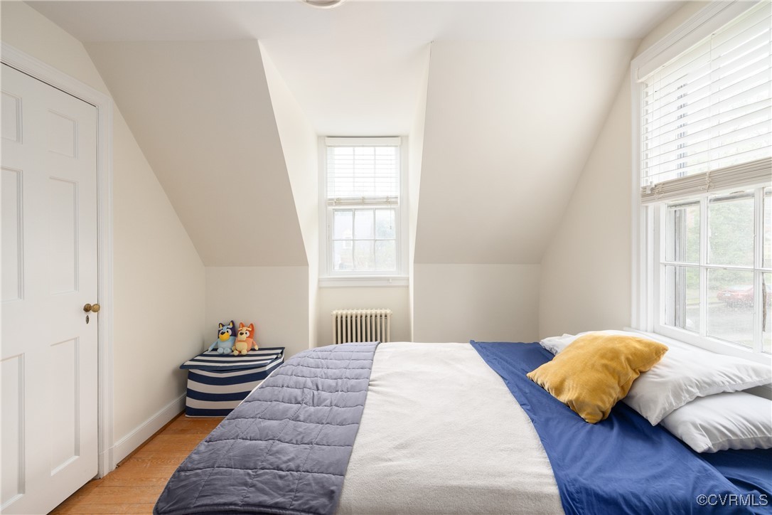 5217 Sylvan Road Richmond, VA 23225 - Photo 28 of 46 a bedroom with a bed and wooden floor