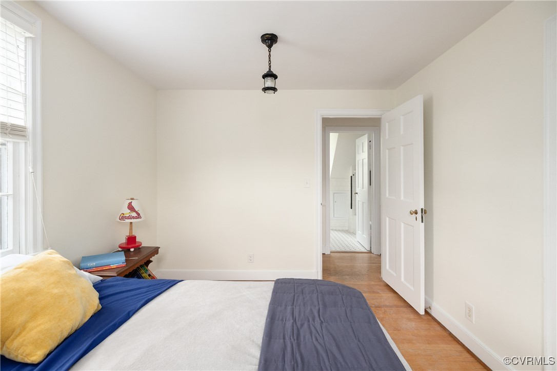 5217 Sylvan Road Richmond, VA 23225 - Photo 29 of 46 a bedroom with bed and wooden floor