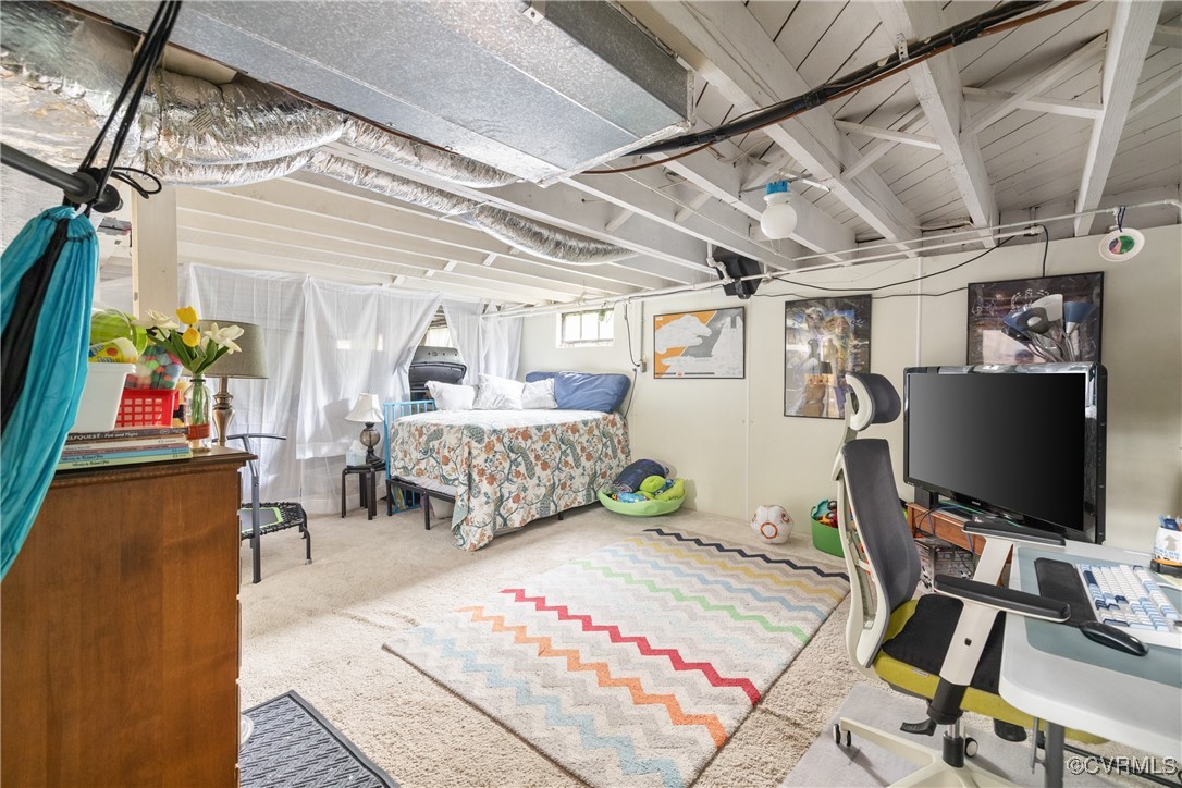 5217 Sylvan Road Richmond, VA 23225 - Photo 32 of 46 a bedroom with furniture and a flat screen tv