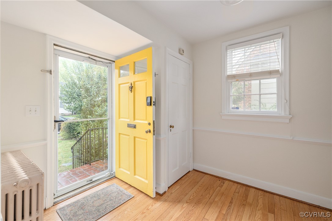 5217 Sylvan Road Richmond, VA 23225 - Photo 5 of 46 a view of an empty room with wooden floor and a window