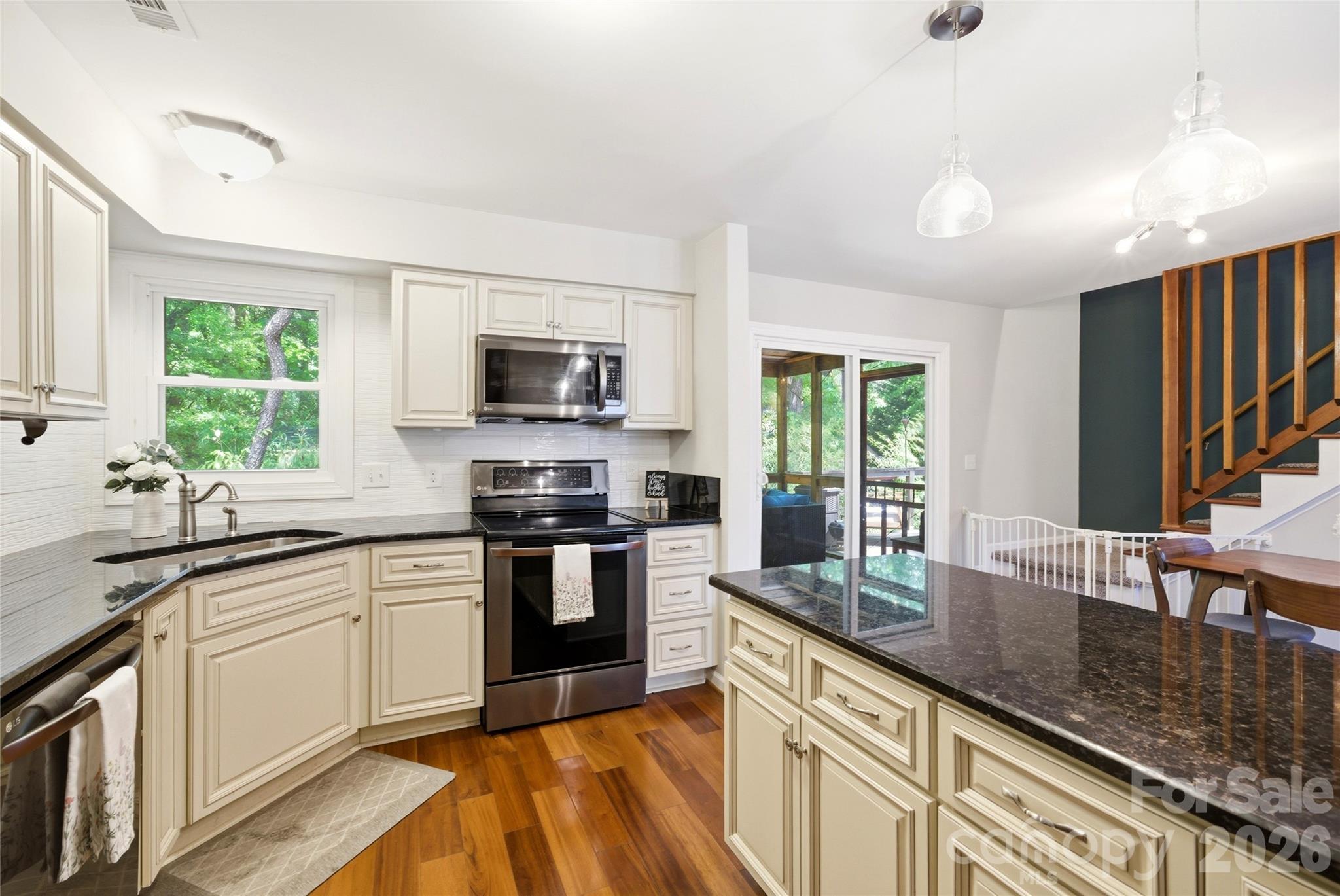 3066 Point Clear Drive Fort Mill, SC 29708 - Photo 15 of 47 a kitchen with stainless steel appliances granite countertop a sink stove microwave and refrigerator