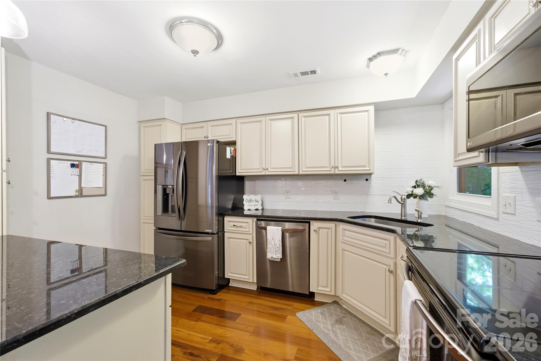 3066 Point Clear Drive Fort Mill, SC 29708 - Photo 17 of 47 a kitchen with granite countertop a refrigerator and a sink