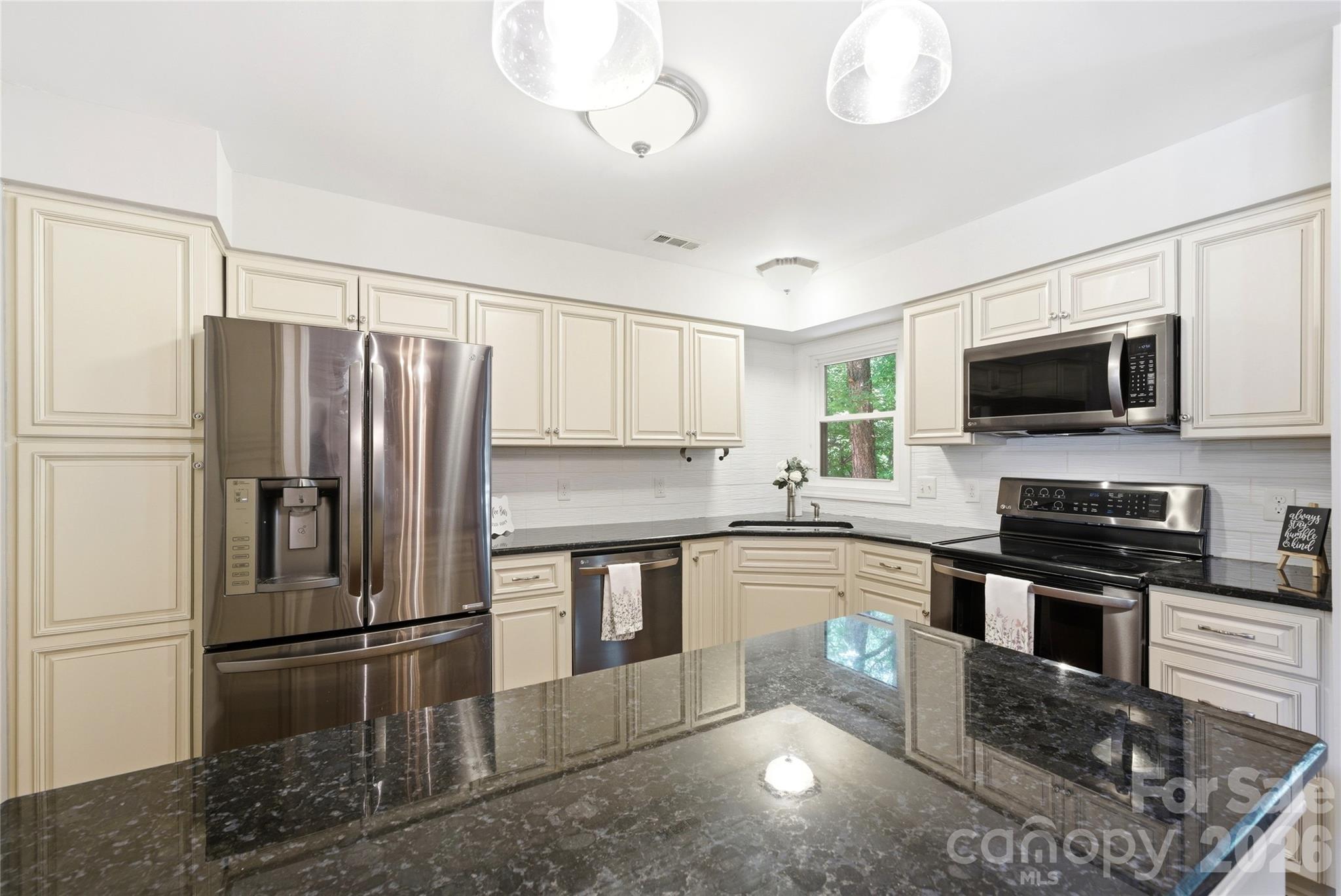 3066 Point Clear Drive Fort Mill, SC 29708 - Photo 18 of 47 a kitchen with stainless steel appliances granite countertop a refrigerator a stove a sink and a microwave